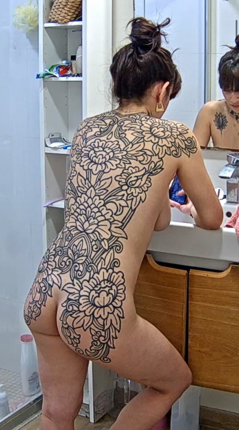 Tatooed girl taking a shower