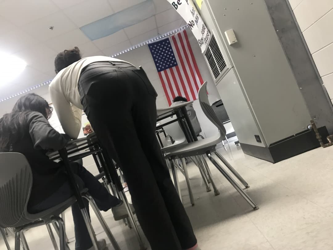 Candid teacher helping students