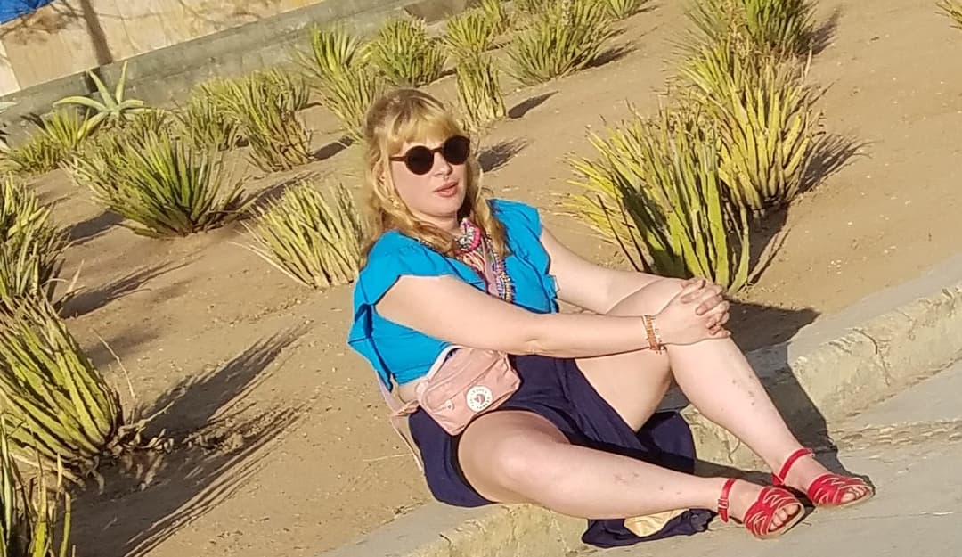 blonde sitting, legs open, nice thick legs