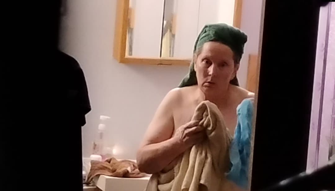 Peeking at my 60-year-old mother getting dressed after taking a shower.