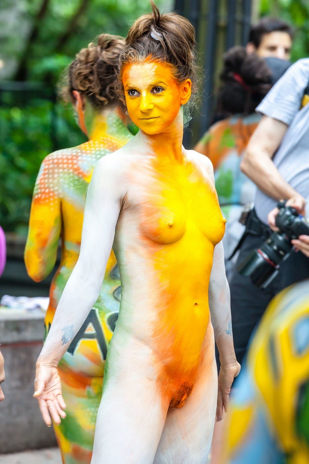 Nudist girls doing body paint in public
