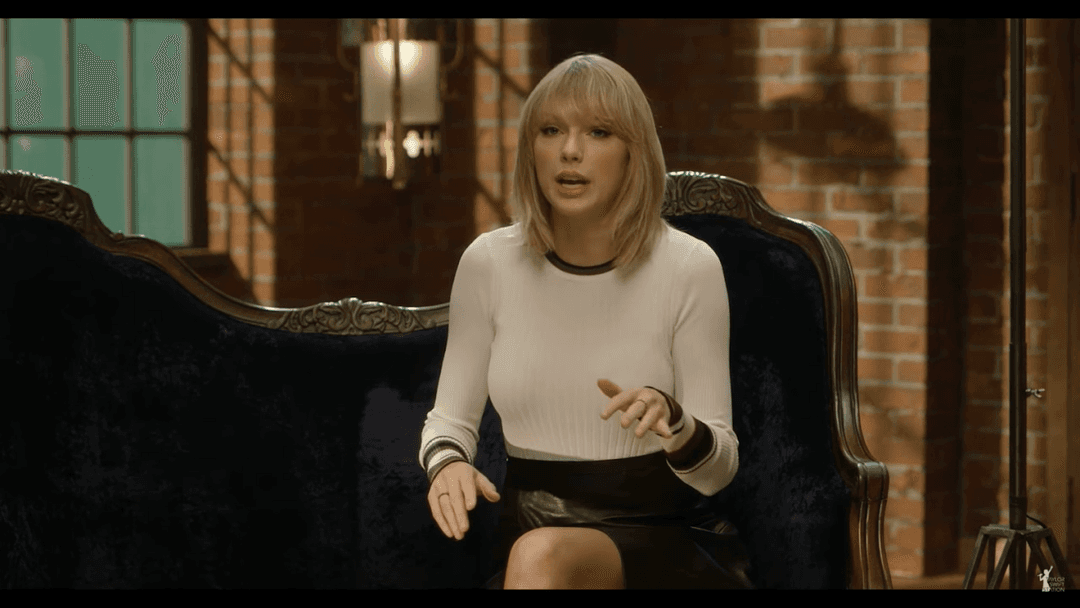 Taylor Swift tight white sweater, leather skirt, leather heels