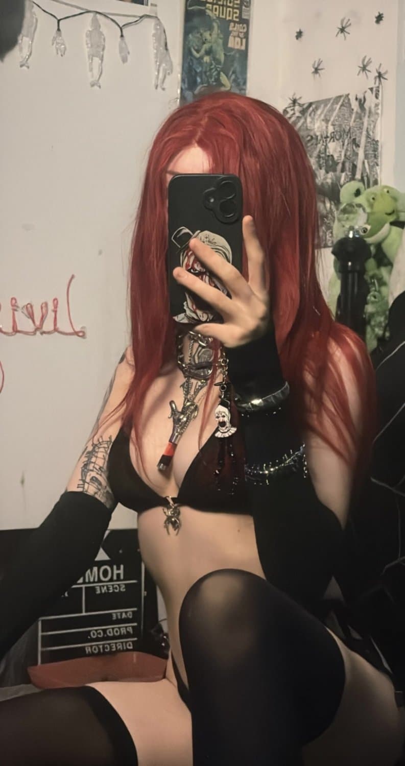 Black lace, red hair, and a soul you’ll never own