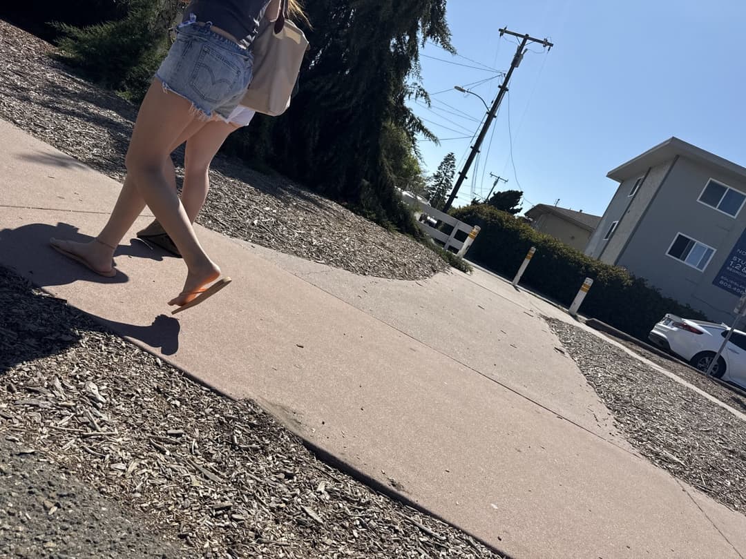 college young white native speaking sole smacking sandals at the beach