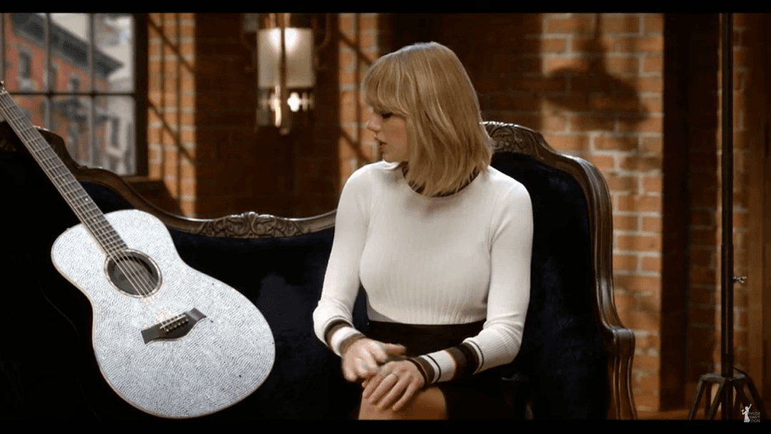 Taylor Swift tight white sweater, leather skirt, leather heels