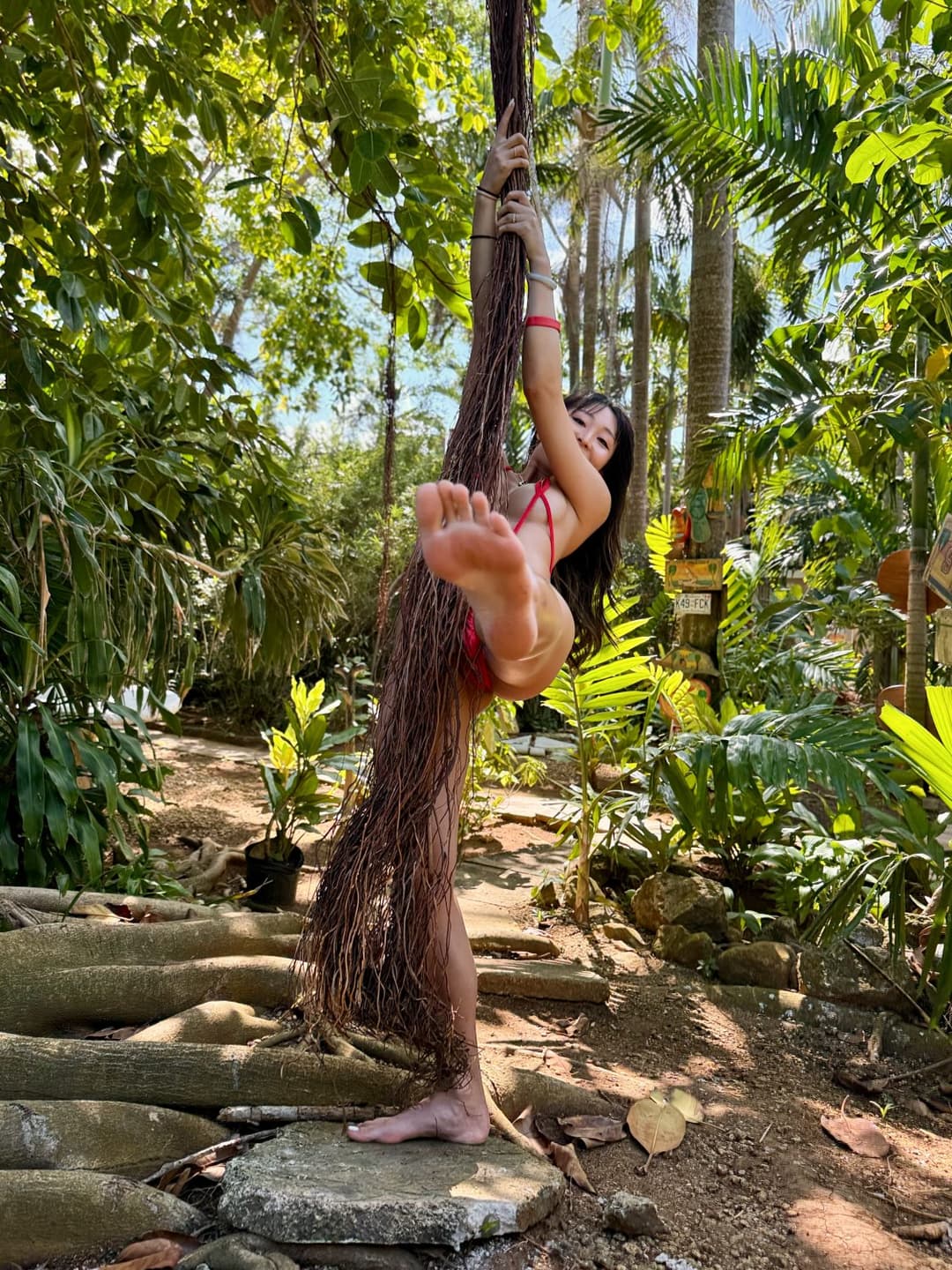 Walking around barefoot and showing off her sexy soles at this lush resort