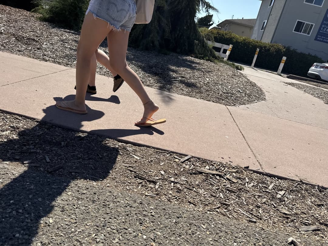 college young white native speaking sole smacking sandals at the beach