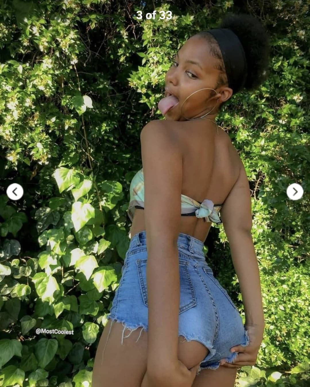 Sexy black teen sticking her tongue out and grabbing her ass