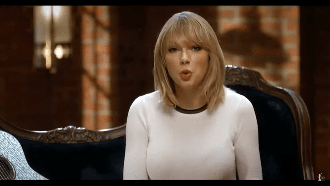 Taylor Swift tight white sweater, leather skirt, leather heels