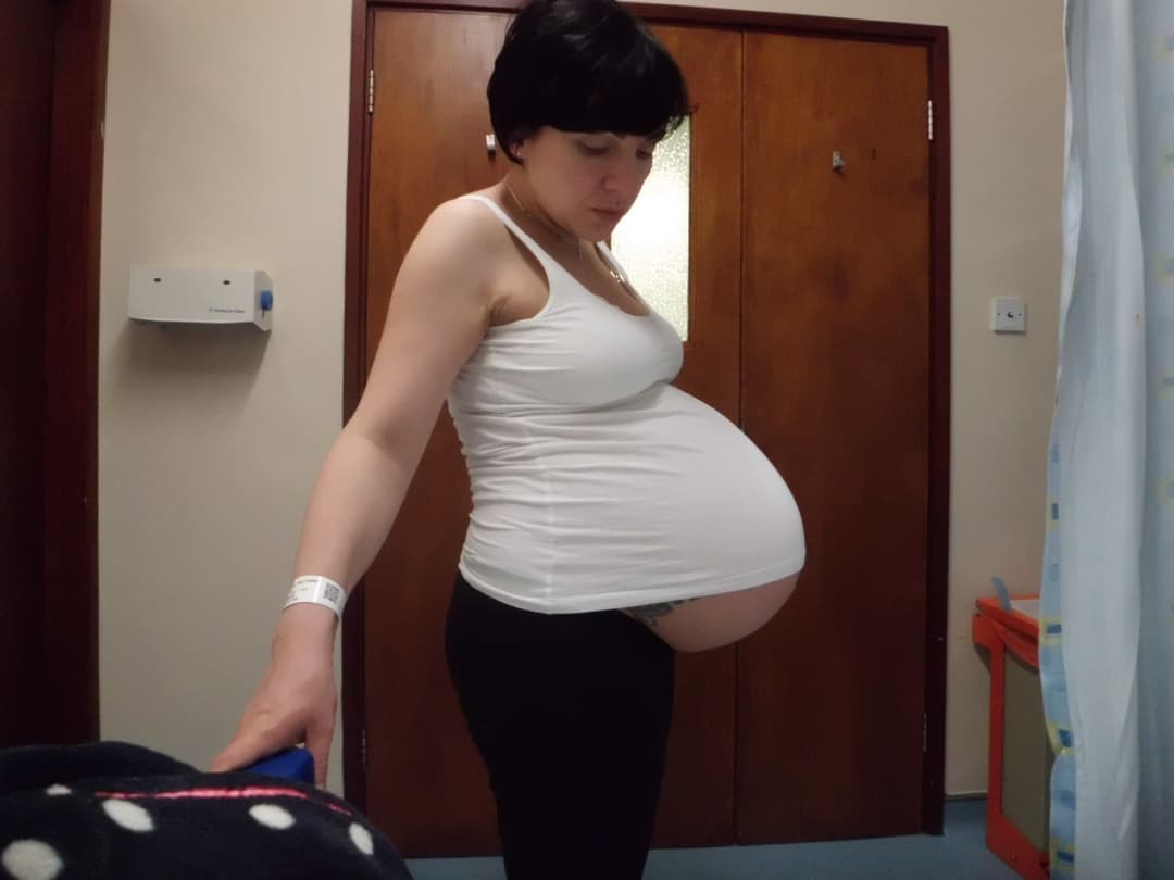 Repost 10 times and I will drop her top to reveal pregnant breasts and belly.