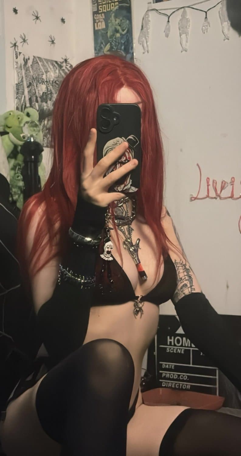 Black lace, red hair, and a soul you’ll never own