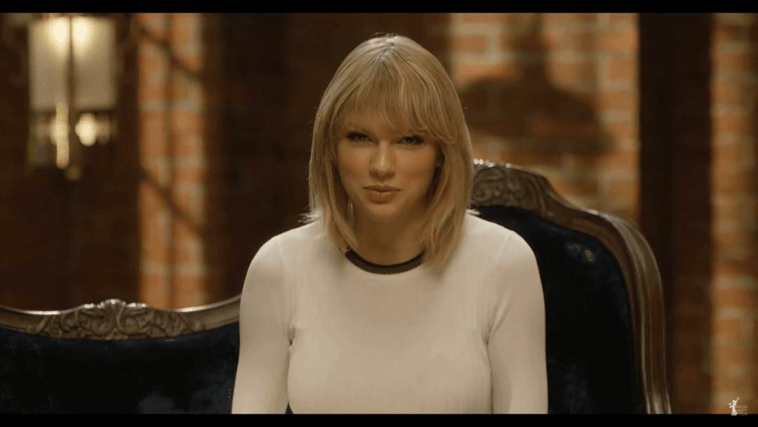 Taylor Swift tight white sweater, leather skirt, leather heels