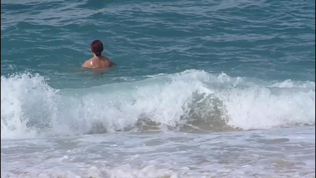 Red head with nice ass topless on the beach