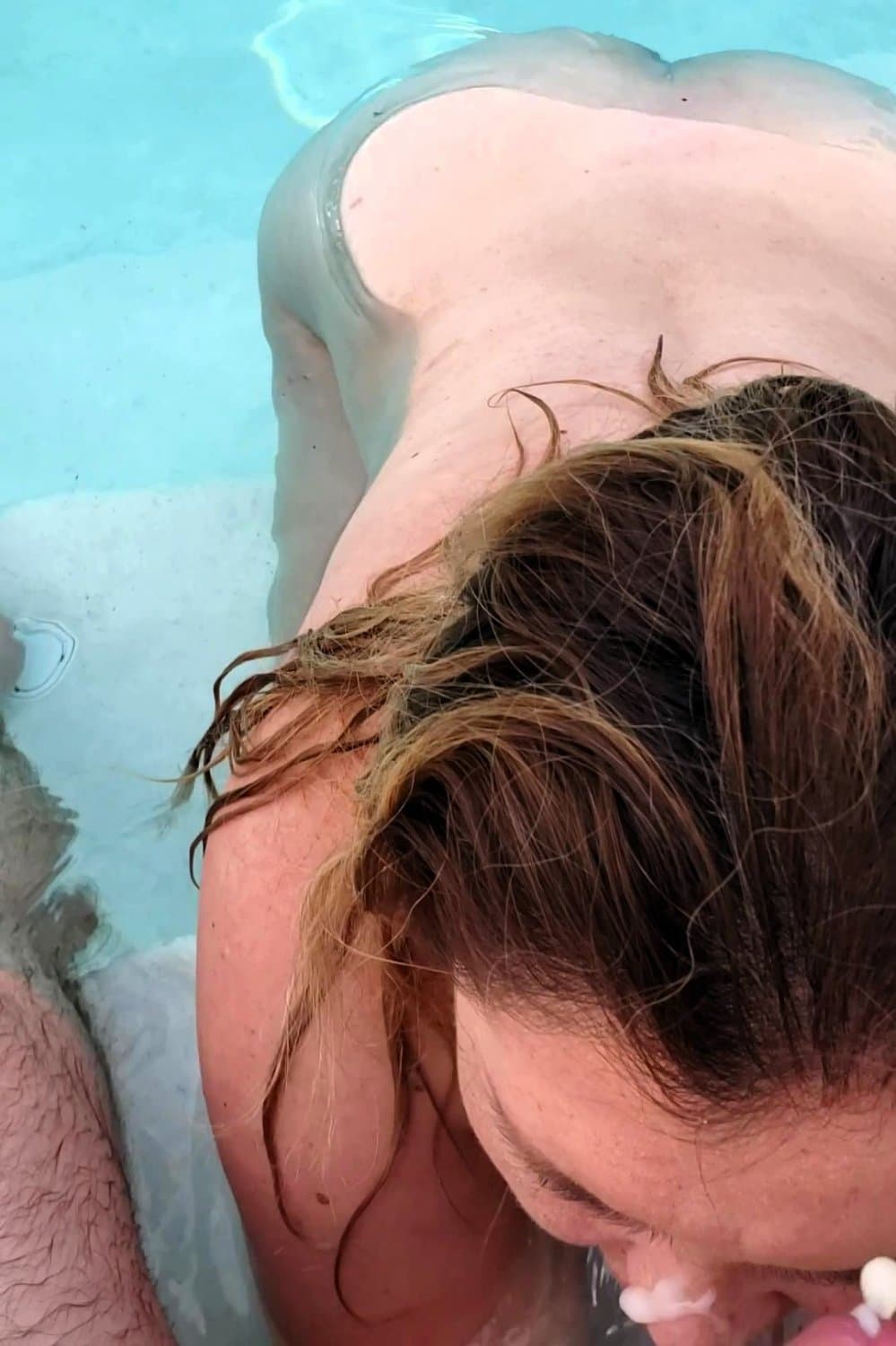 big boobed wife takes a facial in the pool