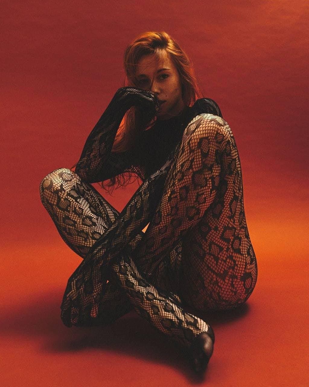 Sexy brunette in fishnets pantyhose