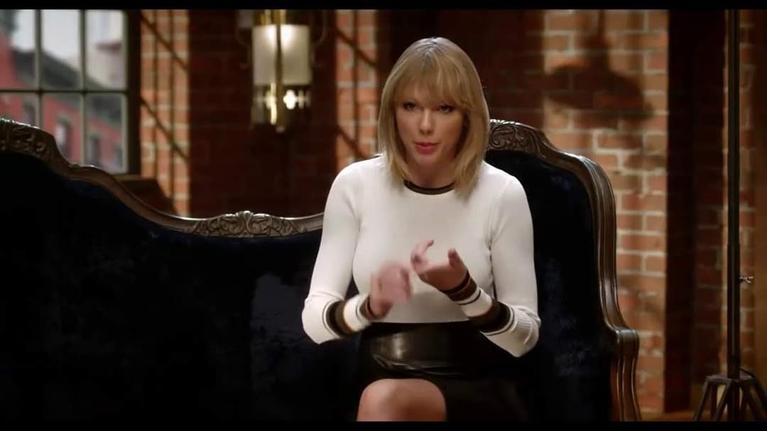 Taylor Swift tight white sweater, leather skirt, leather heels