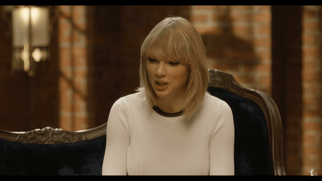 Taylor Swift tight white sweater, leather skirt, leather heels