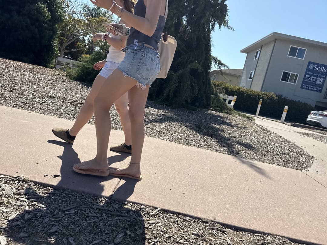 college young white native speaking sole smacking sandals at the beach