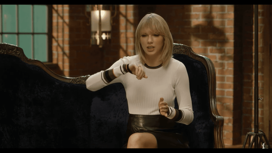 Taylor Swift tight white sweater, leather skirt, leather heels