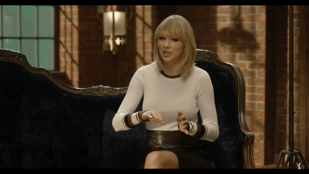 Taylor Swift tight white sweater, leather skirt, leather heels