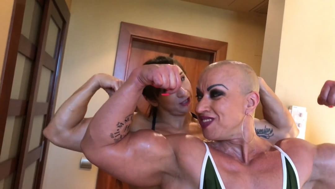 Click to view full size Mrs Bayres, hands on the enormous muscles of Mrs Sanchez