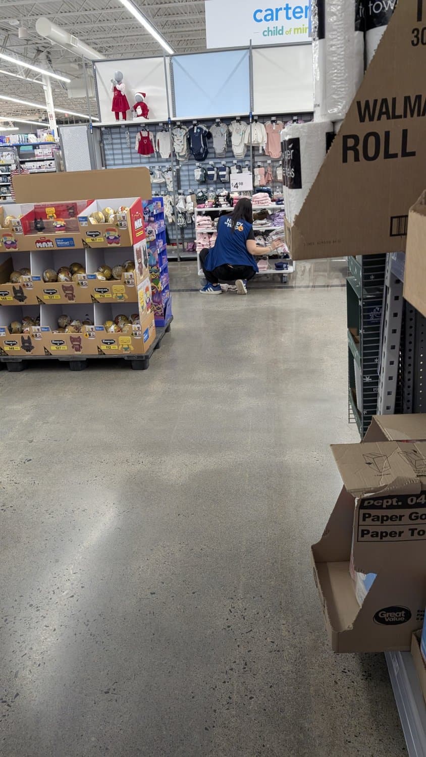 Creepshots of Lindsay doing a split while arranging clothes in apparel. Zoom in for panty shot.