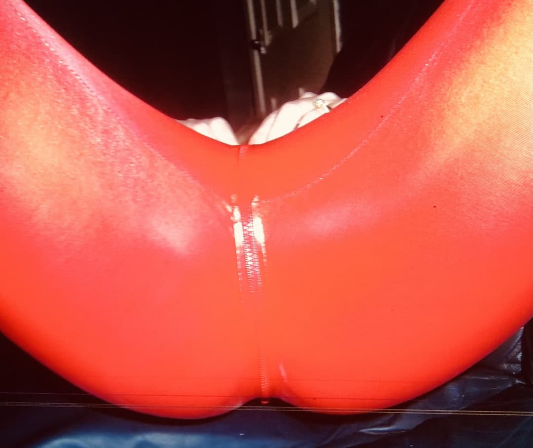 English petite biker milf in red pvc catsuit strips naked again tattoos and pierced nipples