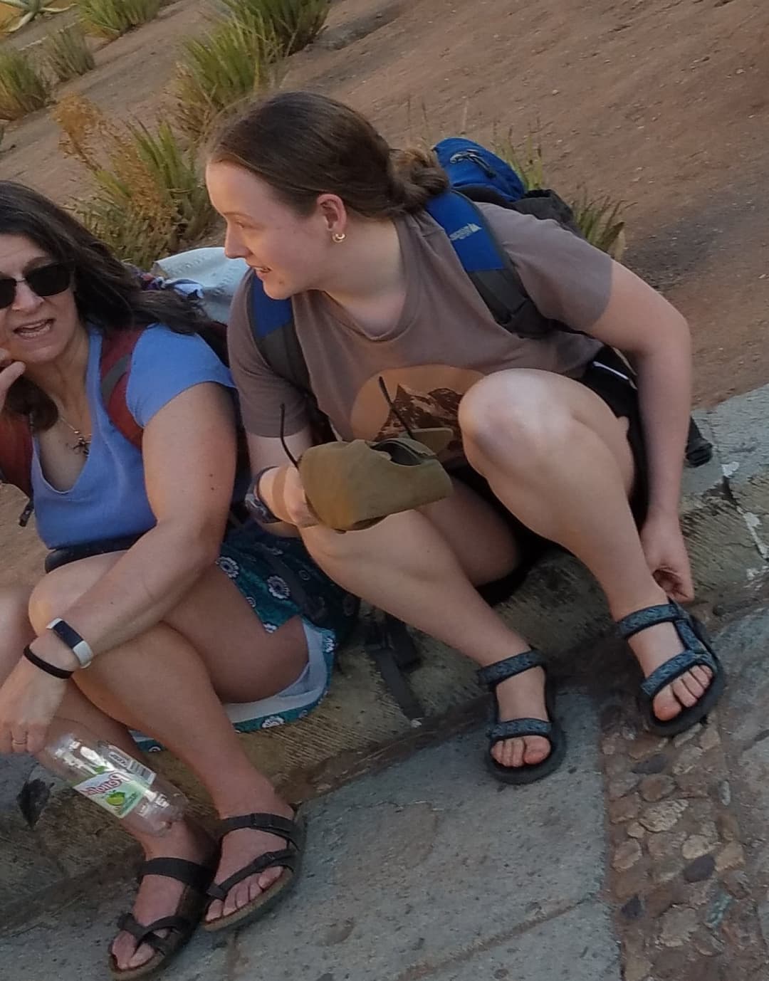 some girls sitting, showing legs and little else