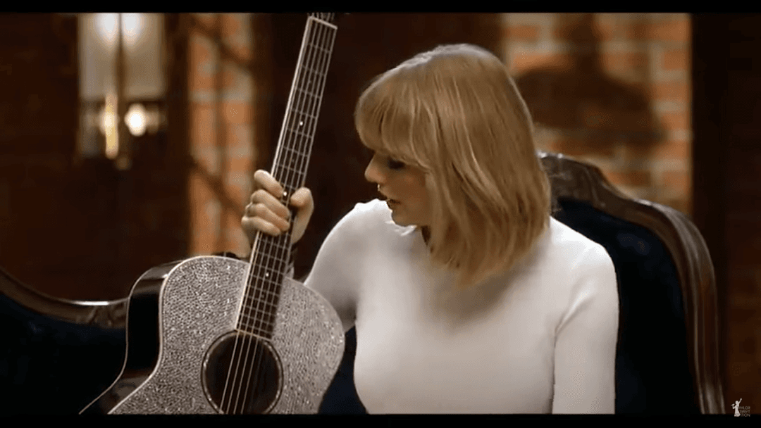 Taylor Swift tight white sweater, leather skirt, leather heels