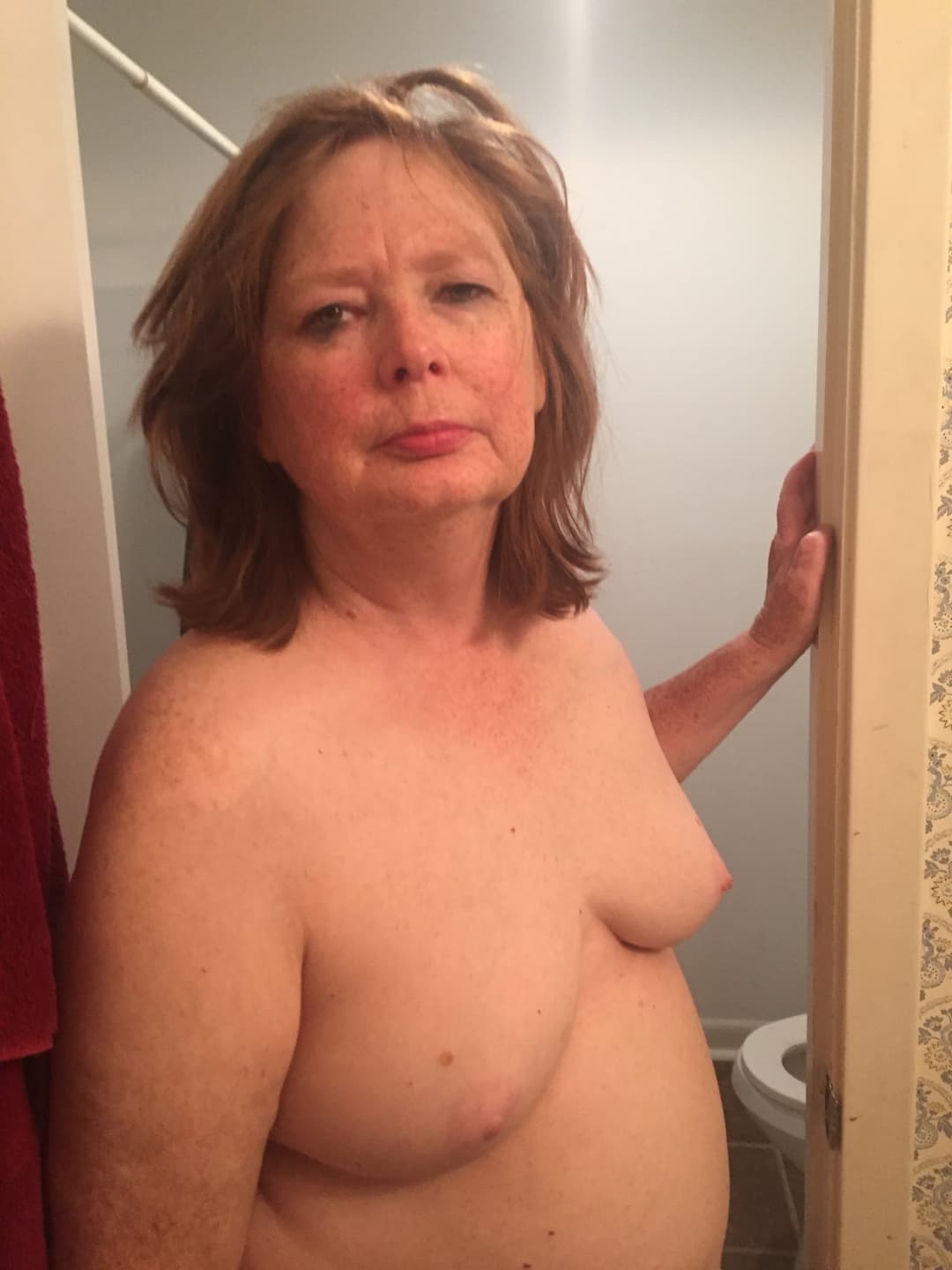 A chubby mature woman likes to walk around the house naked.