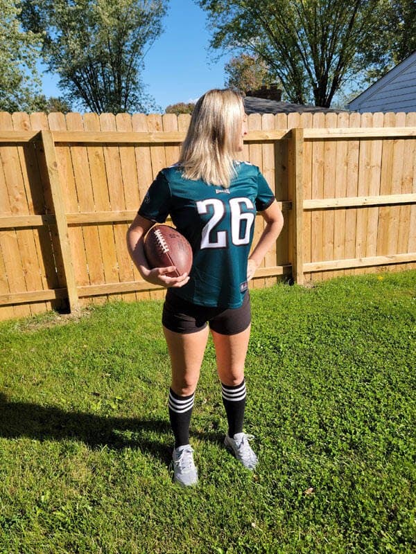 Hotwife wearing Philadelphia Eagles jersey strips