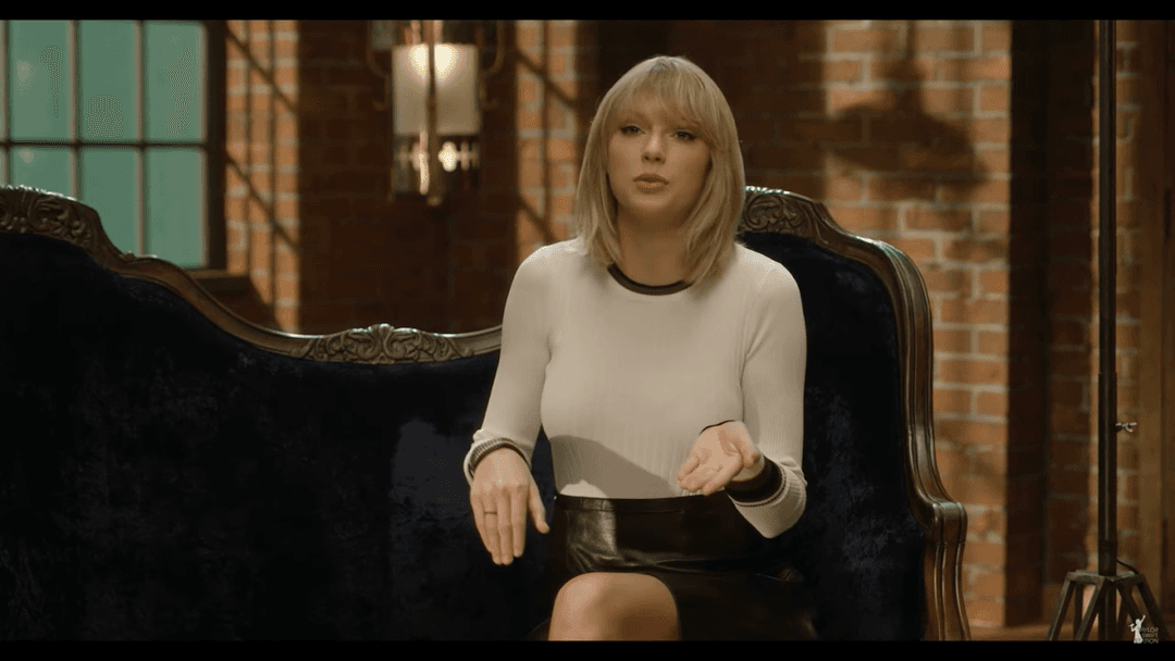 Taylor Swift tight white sweater, leather skirt, leather heels