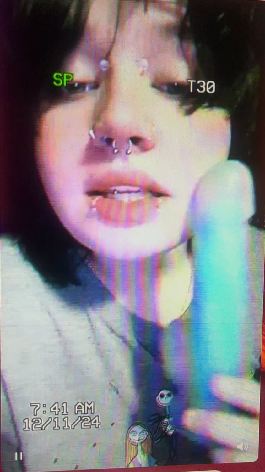 Beautiful goth babe smacking her face with her dildo