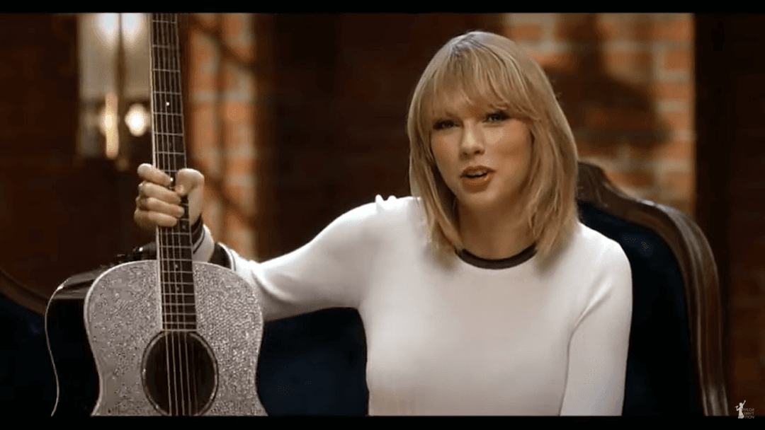 Taylor Swift tight white sweater, leather skirt, leather heels