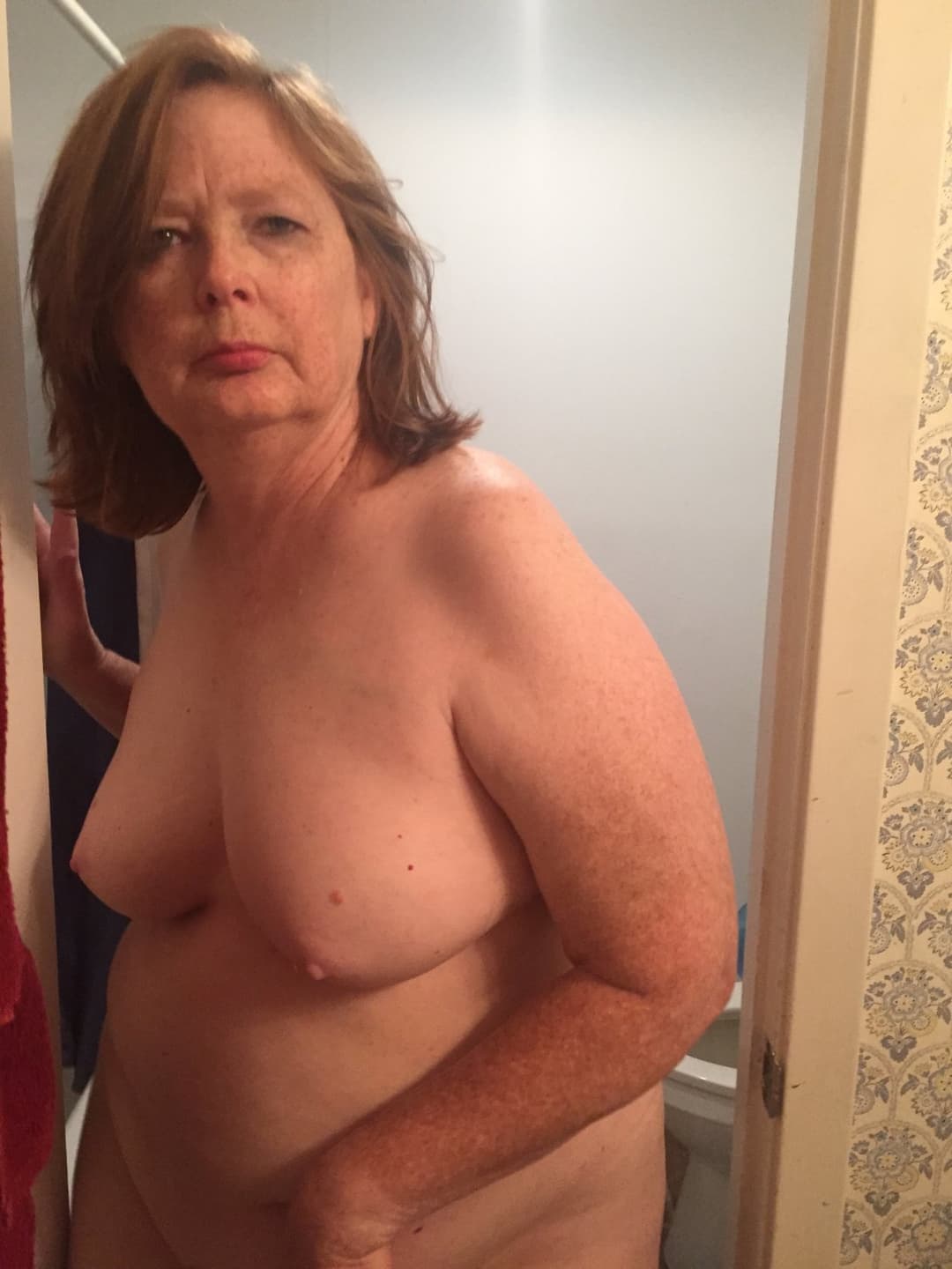 A chubby mature woman likes to walk around the house naked.
