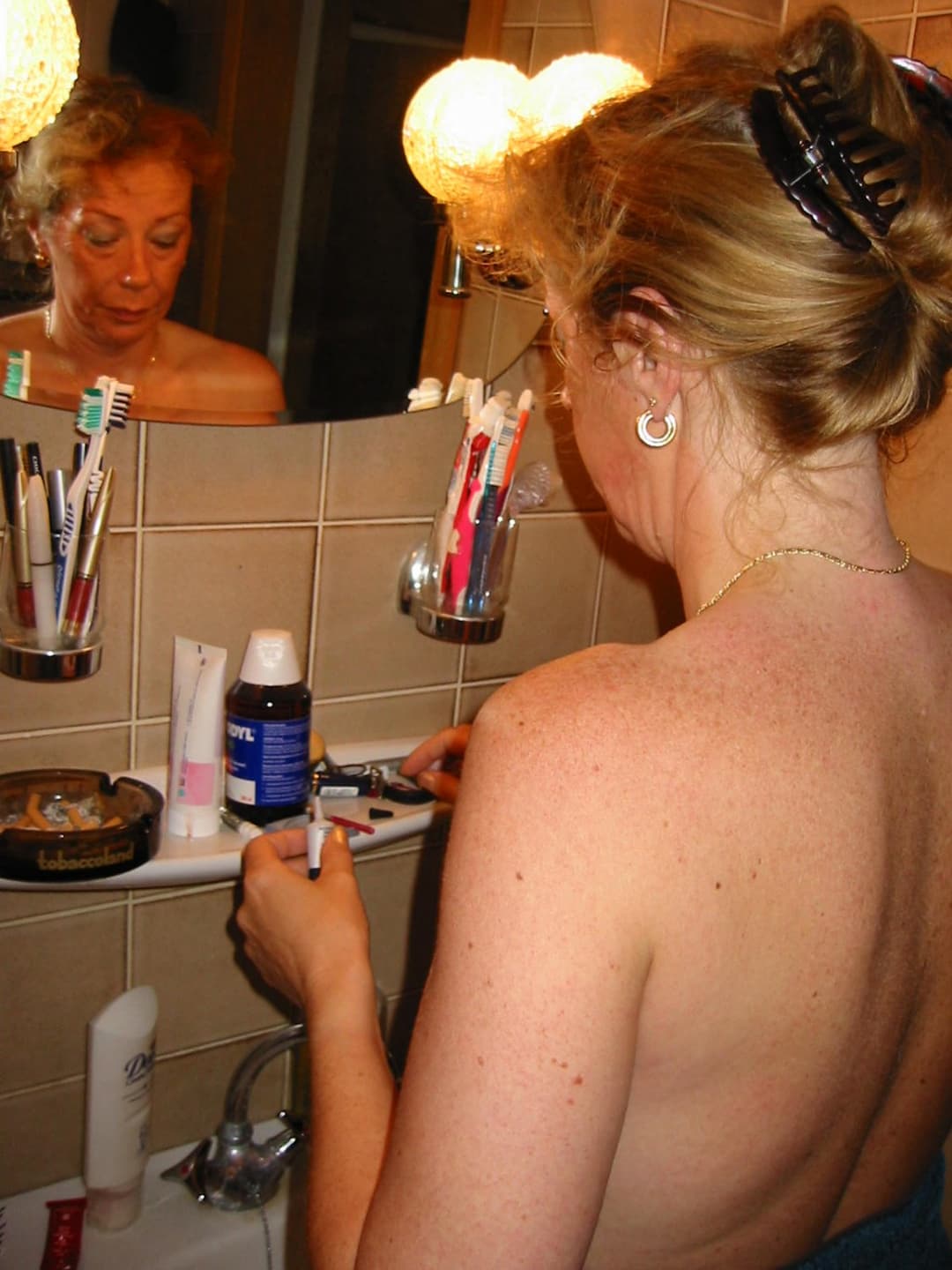 Old slut gets ready for friends in the bathroom