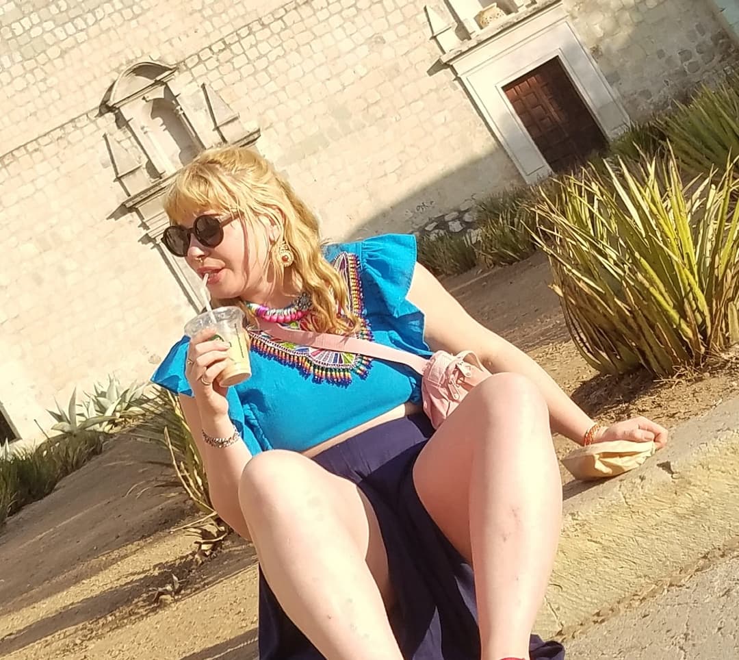blonde sitting, legs open, nice thick legs