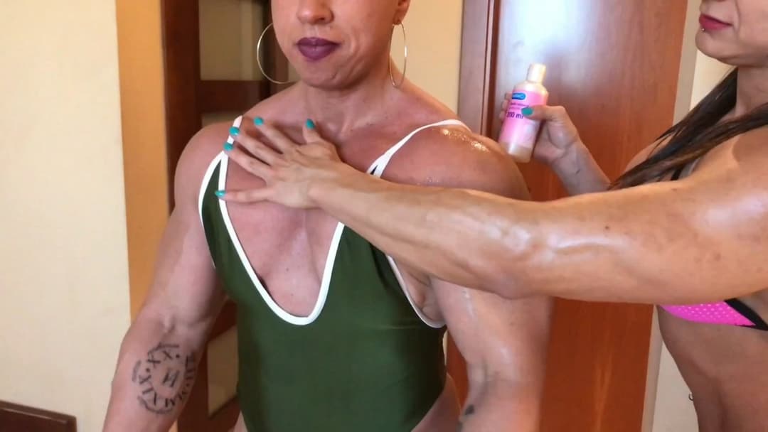 Click to view full size Mrs Bayres, hands on the enormous muscles of Mrs Sanchez
