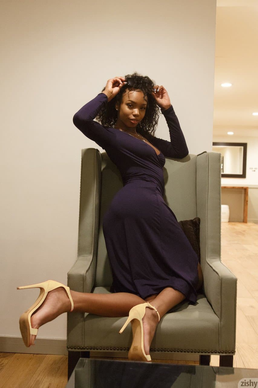 Click to view full size Curly haired beauty Asia Amour flashing her natural tits and fabulous butt