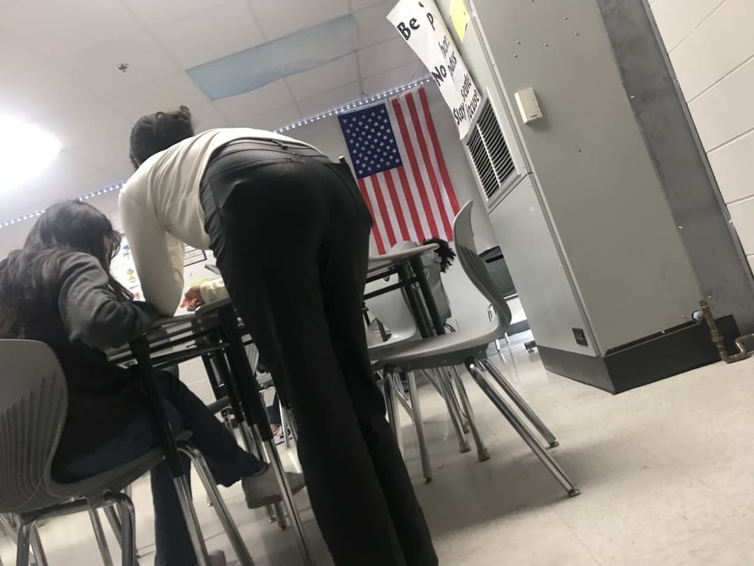 Candid teacher helping students
