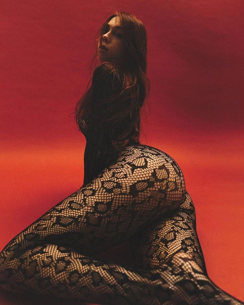 Sexy brunette in fishnets pantyhose