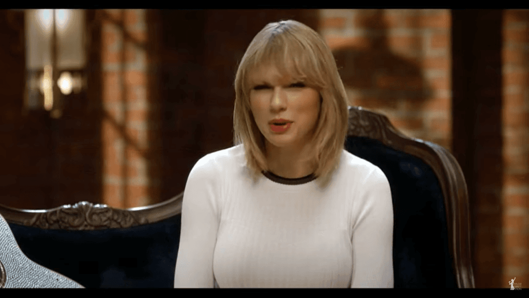 Taylor Swift tight white sweater, leather skirt, leather heels