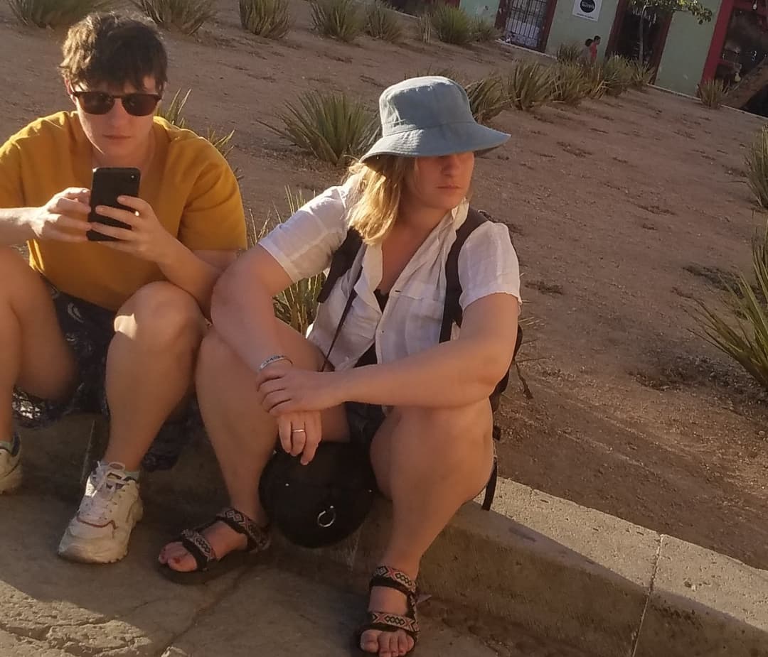 some girls sitting, showing legs and little else
