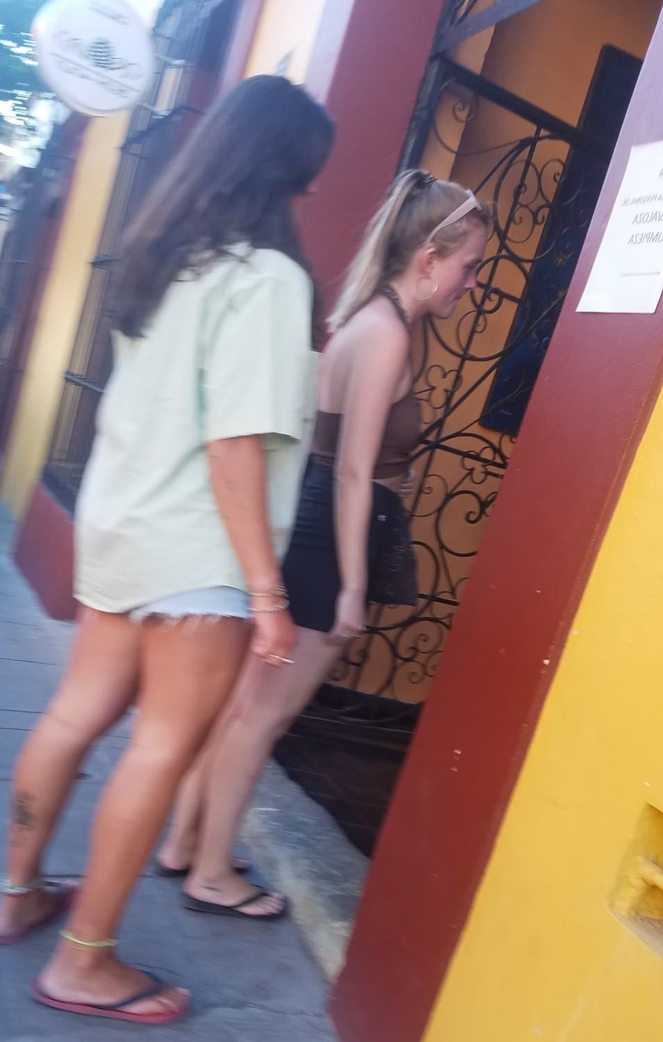 2 friends, blonde and brunette, in shorts, nice legs