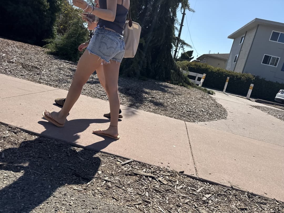 college young white native speaking sole smacking sandals at the beach