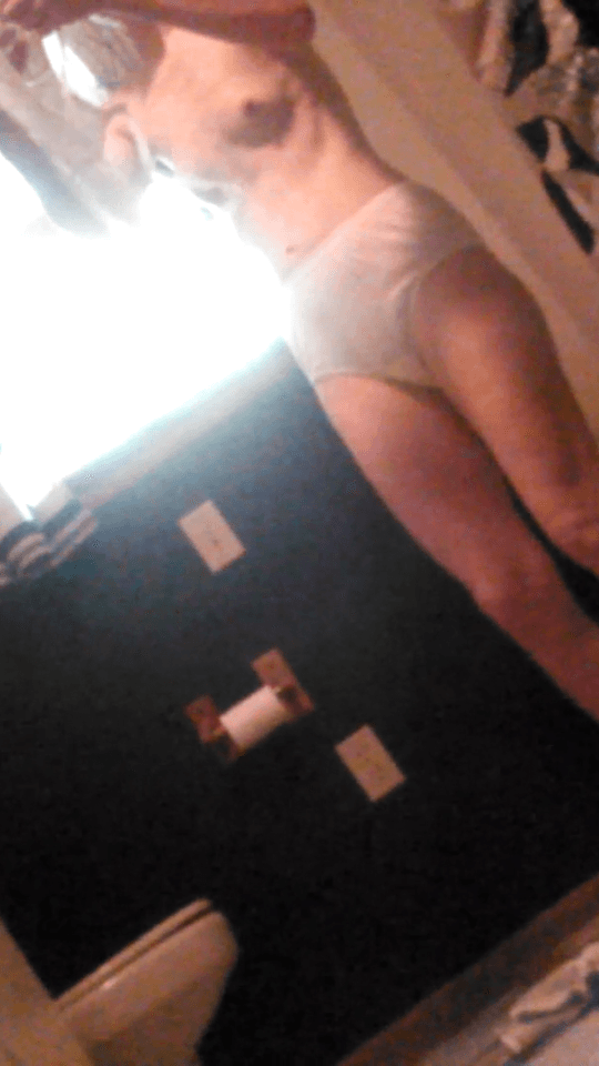 Spying her tiny tits and hairy bush as she puts on her granny panties