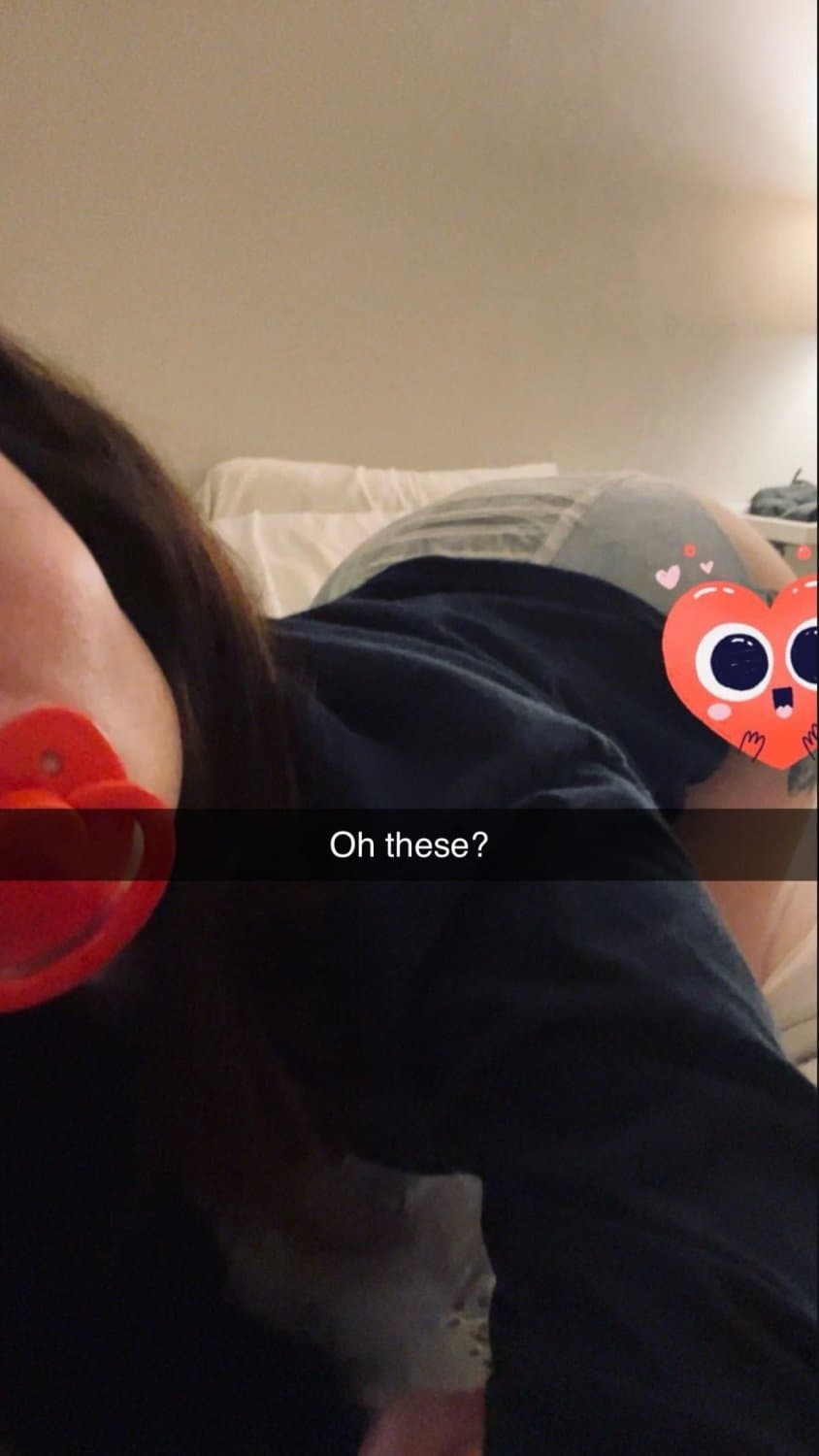 Cute tanned girl shows off her diapers and pull-ups