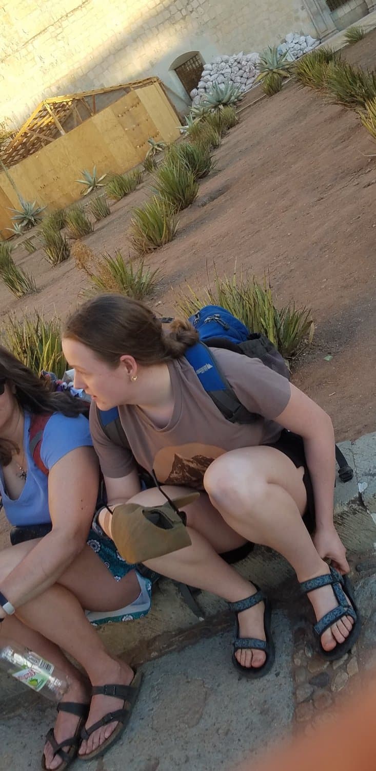 some girls sitting, showing legs and little else