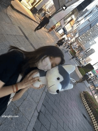 Serious looking AZN college girl behind the scene