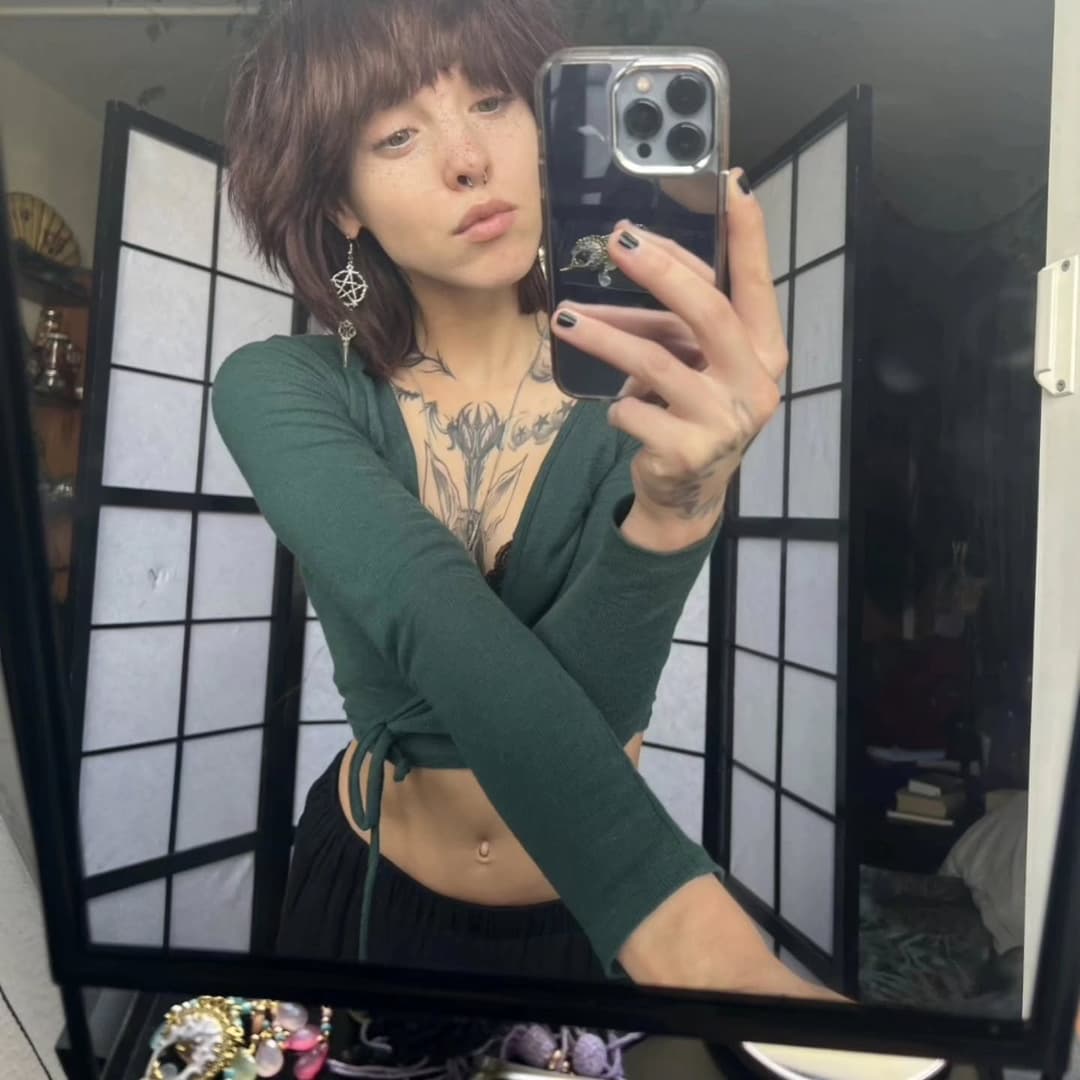 Cute gothic girl with small tits, pointy nipples and a dazzling smile